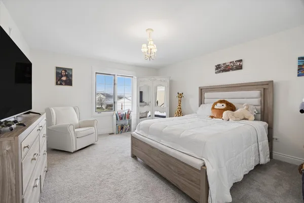 a spacious bedroom with a bed and a couch