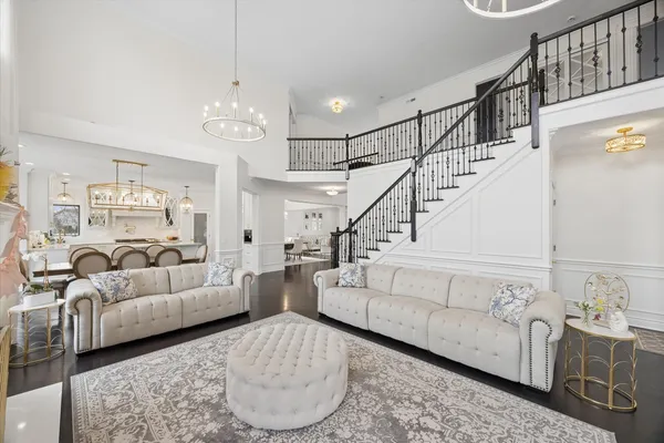 a living room with furniture and a chandelier