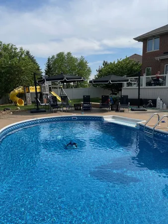 a view of a swimming pool with lounge chair