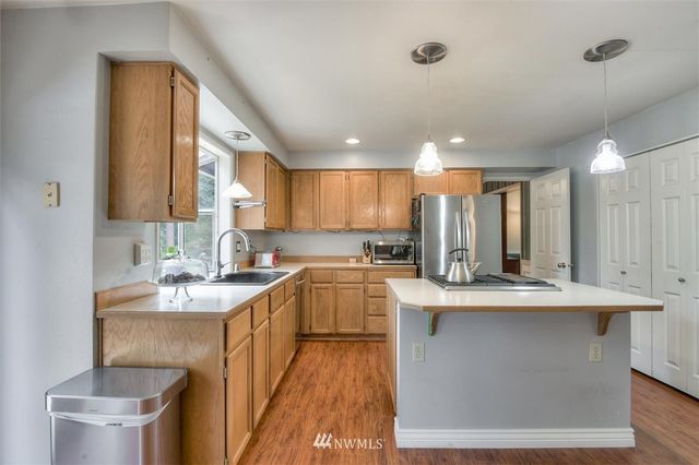 a kitchen with a sink stove and cabinets