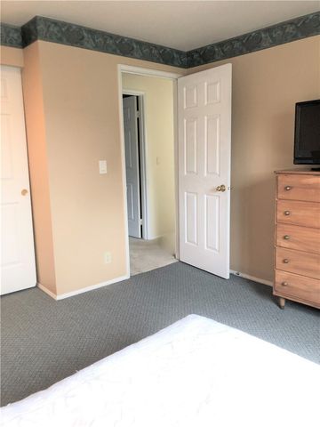 a view of walk in closet with hardwood floor