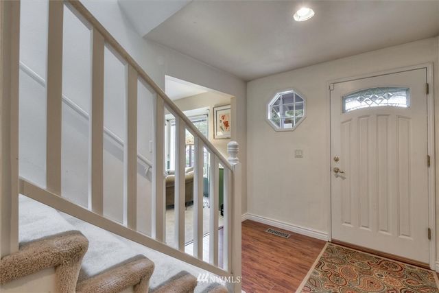 a view of an entryway with wooden floor