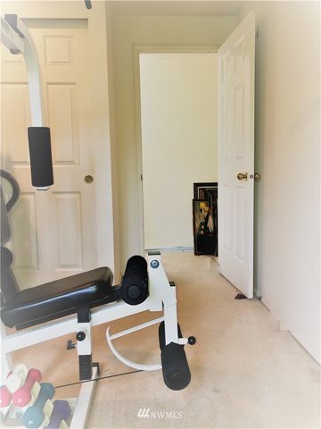 a room with gym equipment and view of living room