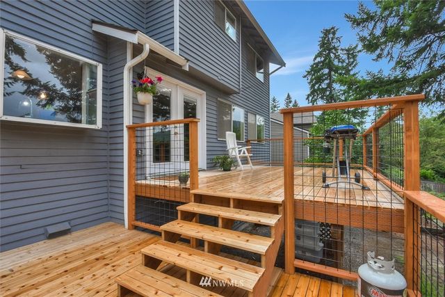 a view of a balcony with a potted plant and a large window