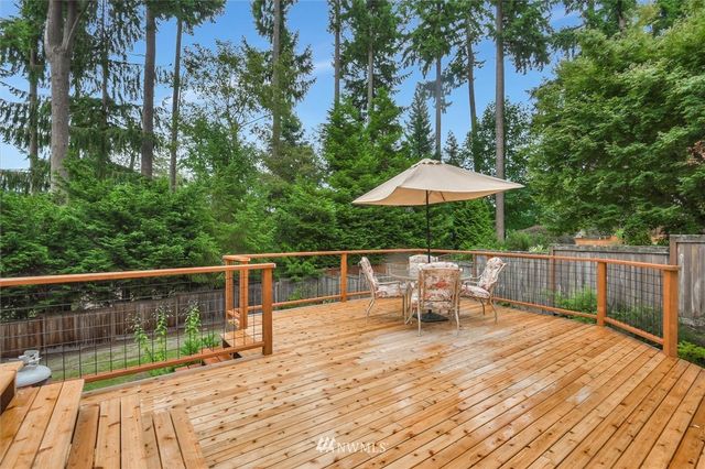 a view of balcony with wooden floor and outdoor seating