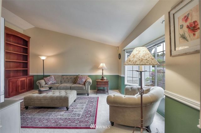 a living room with furniture a lamp and a window