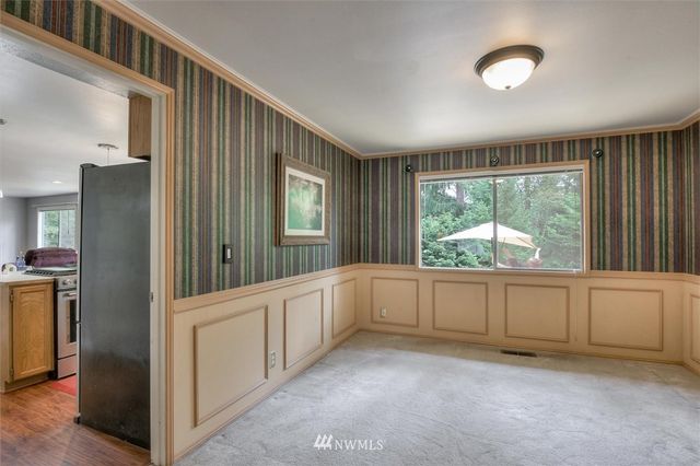 a view of a kitchen with an entryway and a window