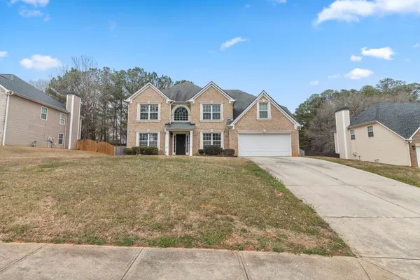 a front view of a house with a yard