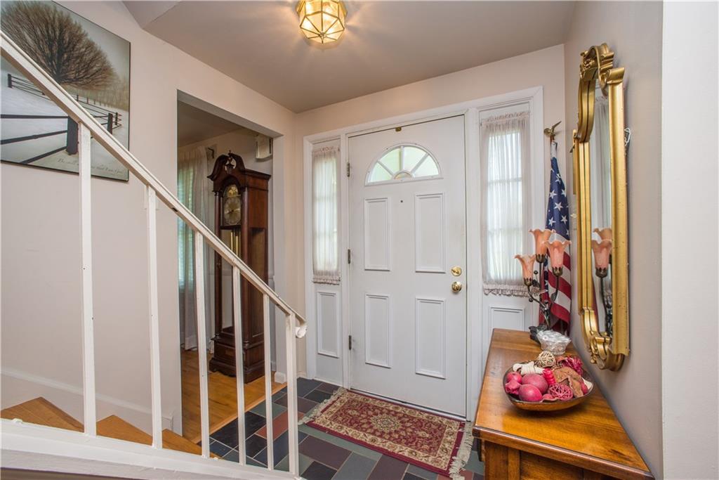 1484 Mayview Road Pittsburgh, PA 15241 - Photo 2 of 25 Sidelights flanking the front door allow natural light to fill the foyer, creating an inviting space. The four-panel entry door has a fanlight and is fronted by a full-view storm door.