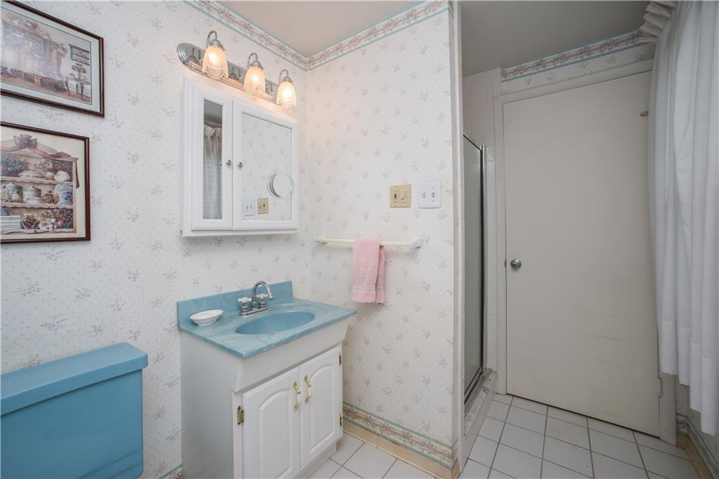 1484 Mayview Road Pittsburgh, PA 15241 - Photo 14 of 25 The semi-private master bath has ceramic tile flooring and a step-in shower with tile walls. The door shown here leads to the second bedroom.