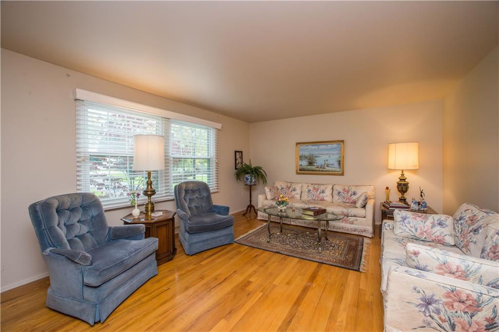 1484 Mayview Road Pittsburgh, PA 15241 - Photo 3 of 25 The living room measures a generous 18x13 and has large windows overlooking the front lawn. The exposed hardwood flooring and neutral wall tones offered here will simplify any interior design plan.