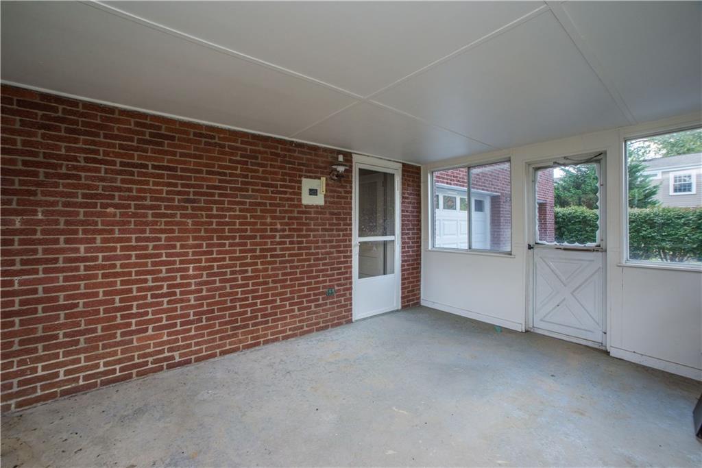 1484 Mayview Road Pittsburgh, PA 15241 - Photo 21 of 25 The enclosed patio is accessed from the unfinished lower level and has a door leading to the rear yard. The lower level offers an unfinished space, with new vinyl flooring, that could be converted to a gameroom. The laundry is also found on the lower level.