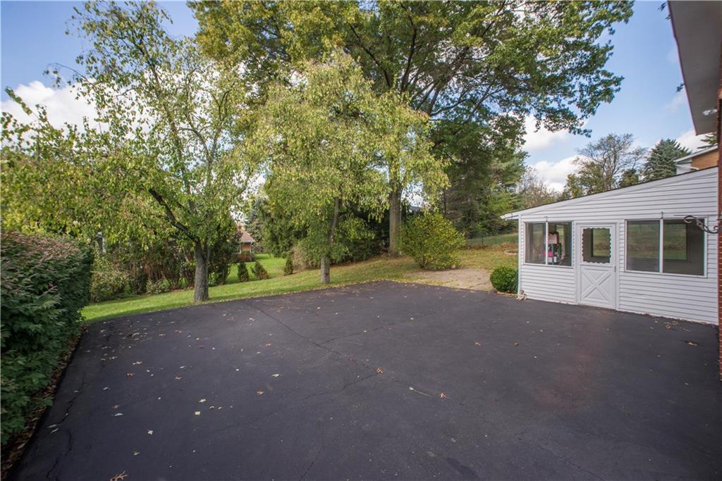 1484 Mayview Road Pittsburgh, PA 15241 - Photo 23 of 25 There is room for sports activities and play as well as bonus guest parking in the wide driveway. This view shows the entry into the enclosed patio on the right, and yard at the far end.