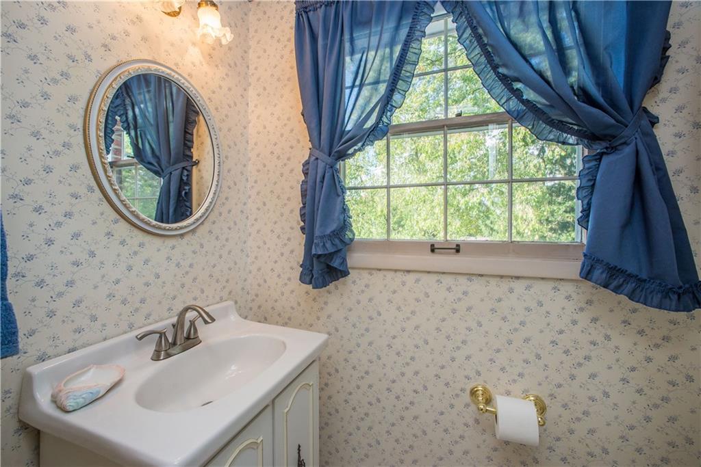1484 Mayview Road Pittsburgh, PA 15241 - Photo 10 of 25 The guest powder room on the first floor has a window facing the rear of the property and is outfitted with ceramic tile floor and vanity sink.