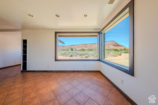 6178 East Zion Road Kanab, UT 84741 - Photo 14 of 48 Empty room with tile patterned floors and a mountain view