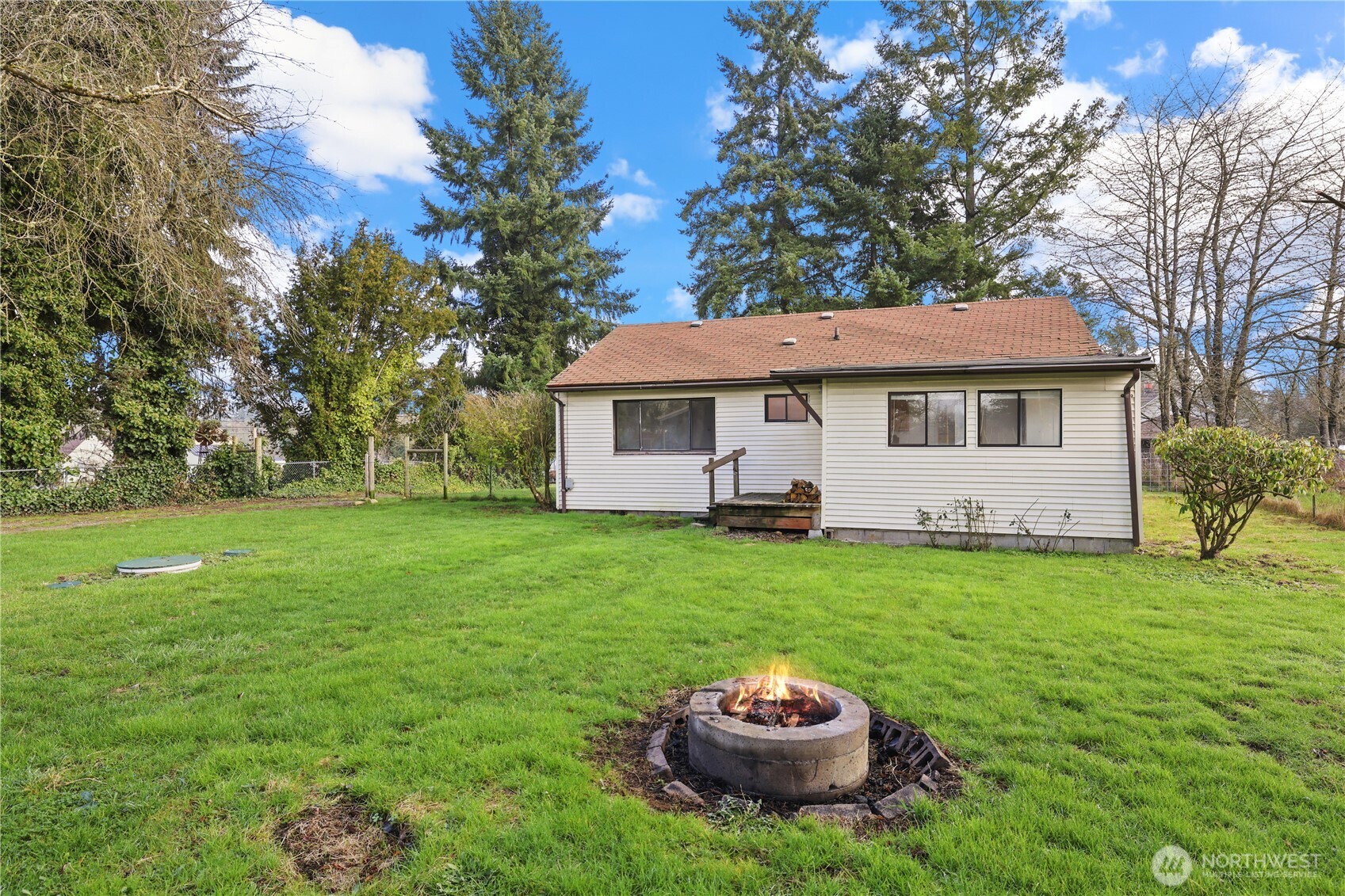 12204 Waller Road East Tacoma, WA 98446 - Photo 21 of 33 a view of a house with a backyard and sitting area