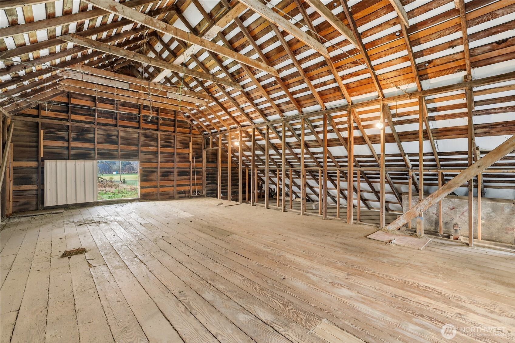 12204 Waller Road East Tacoma, WA 98446 - Photo 27 of 33 a view of an empty room with a wooden floor