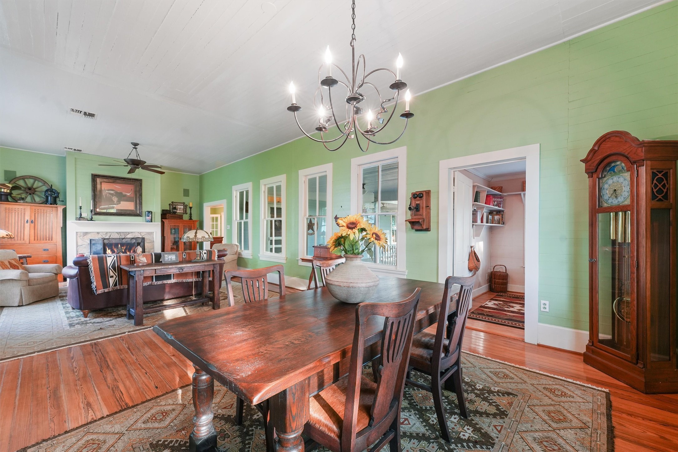9058 Sam Houston Road Brenham, TX 77833 - Photo 12 of 49 a view of a dining room with furniture a chandelier and wooden floor