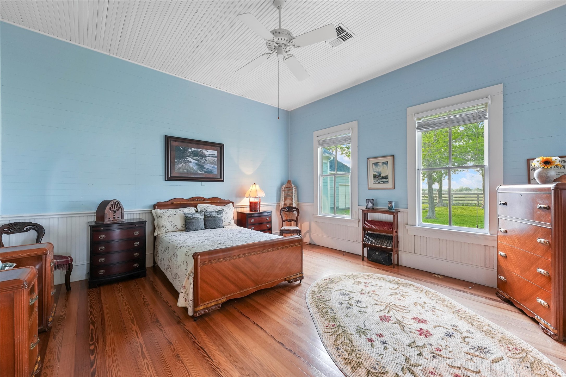 9058 Sam Houston Road Brenham, TX 77833 - Photo 19 of 49 a bedroom with a bed and wooden floor