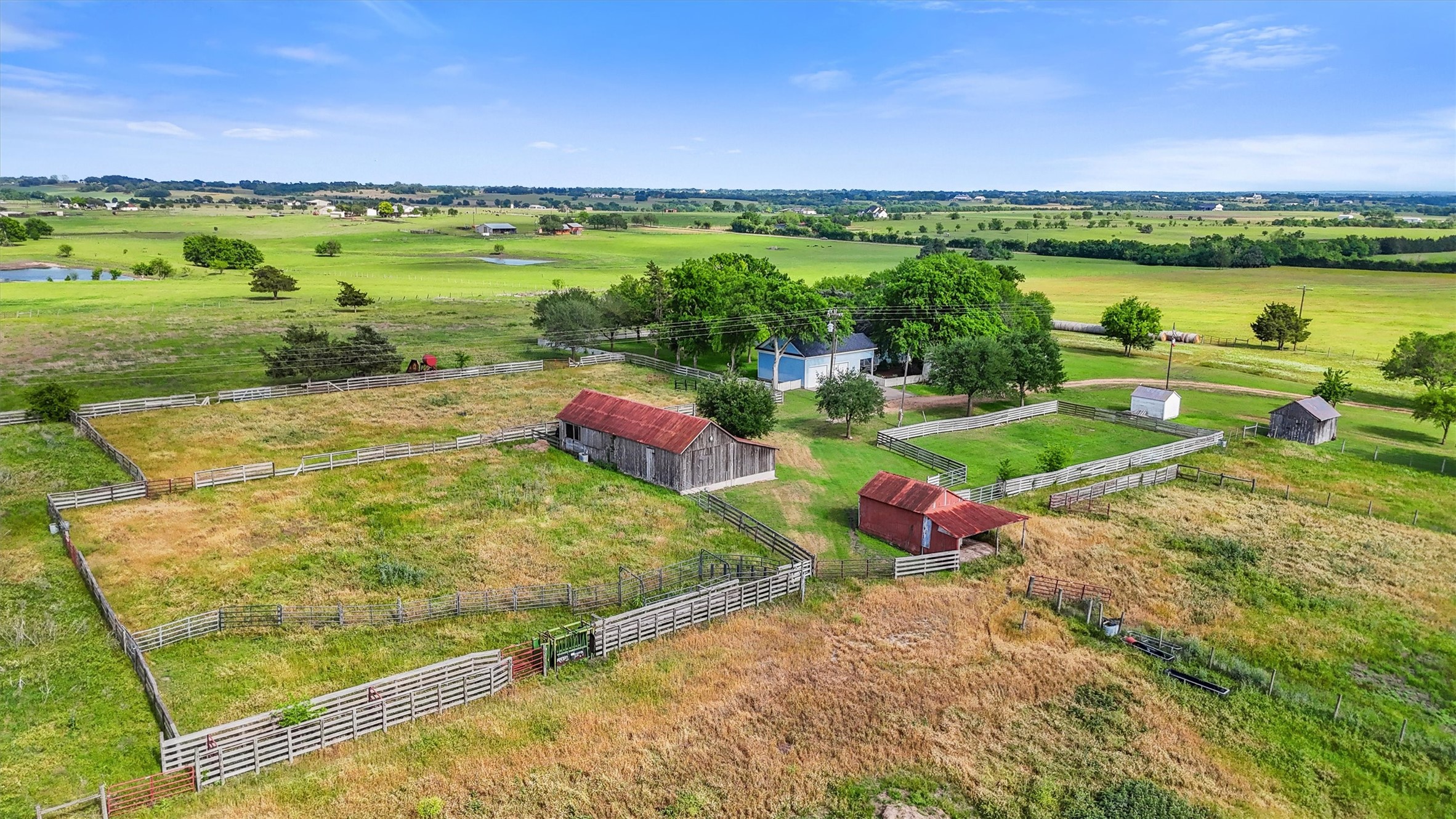 9058 Sam Houston Road Brenham, TX 77833 - Photo 45 of 49 a view of a lake with lawn chairs and large trees