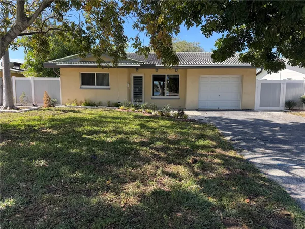 a large kitchen with a refrigerator a counter space and cabinets