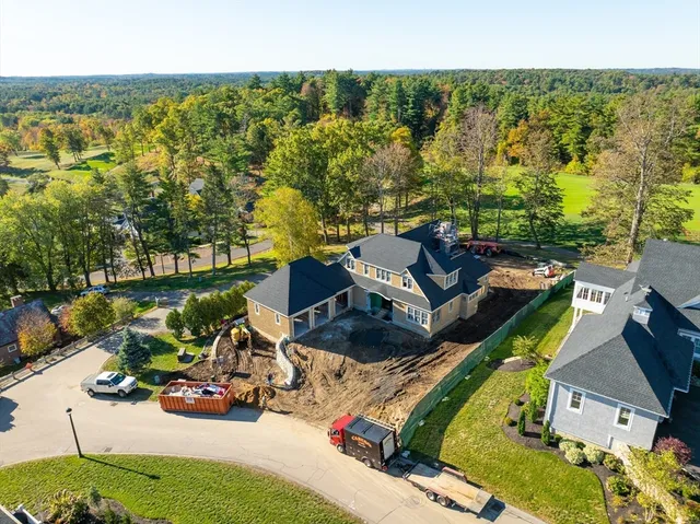 an aerial view of a house with garden space and street view