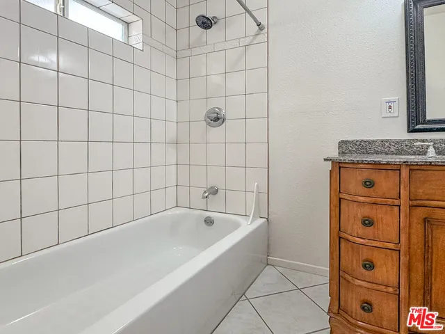 a bathroom with a bathtub and shower