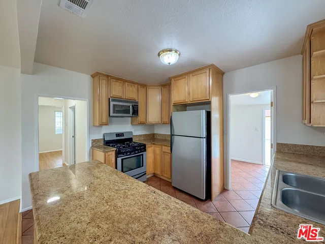 a kitchen with a refrigerator sink and microwave