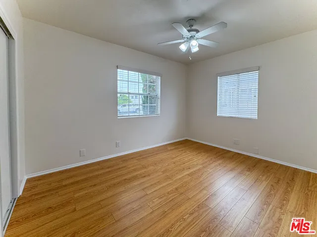 wooden floor in an empty room with a window