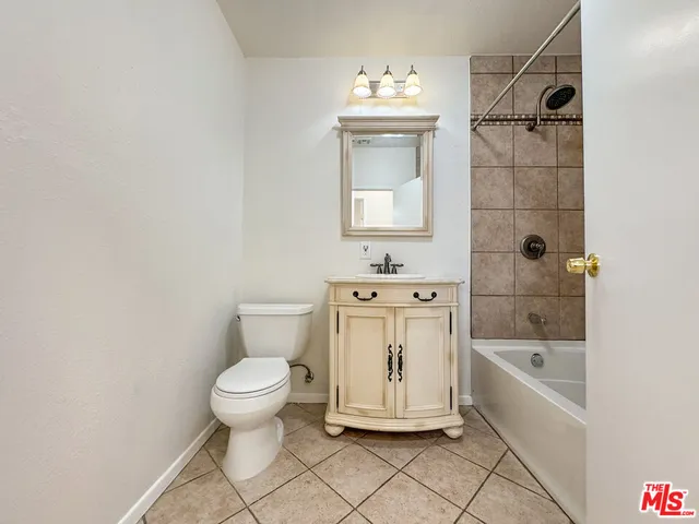 a bathroom with a toilet sink and shower