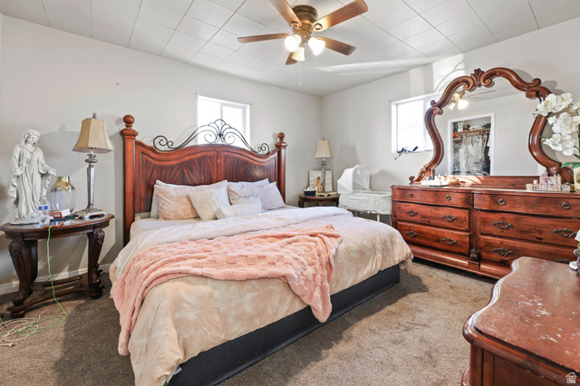 7609 Mountain View Road Lake Point, UT 84074 - Photo 10 of 16 Bedroom featuring multiple windows, carpet, and a ceiling fan