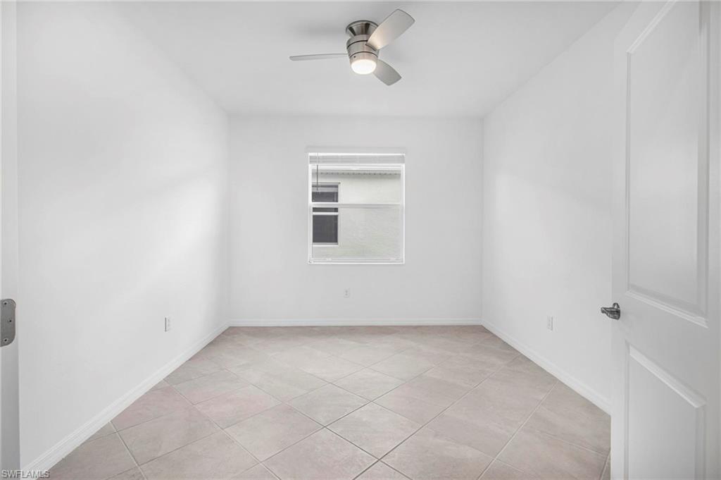 2265 Avocado Lane Naples, FL 34102 - Photo 16 of 32 an empty room with a window and ceiling fan