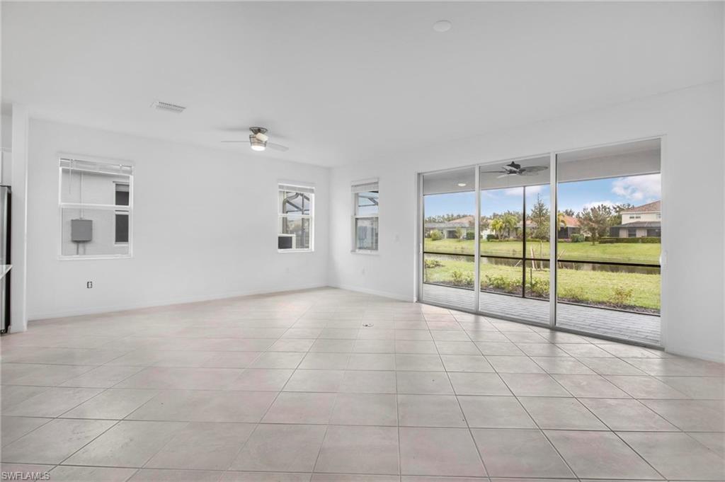 2265 Avocado Lane Naples, FL 34102 - Photo 2 of 32 a view of an empty room with a sliding door