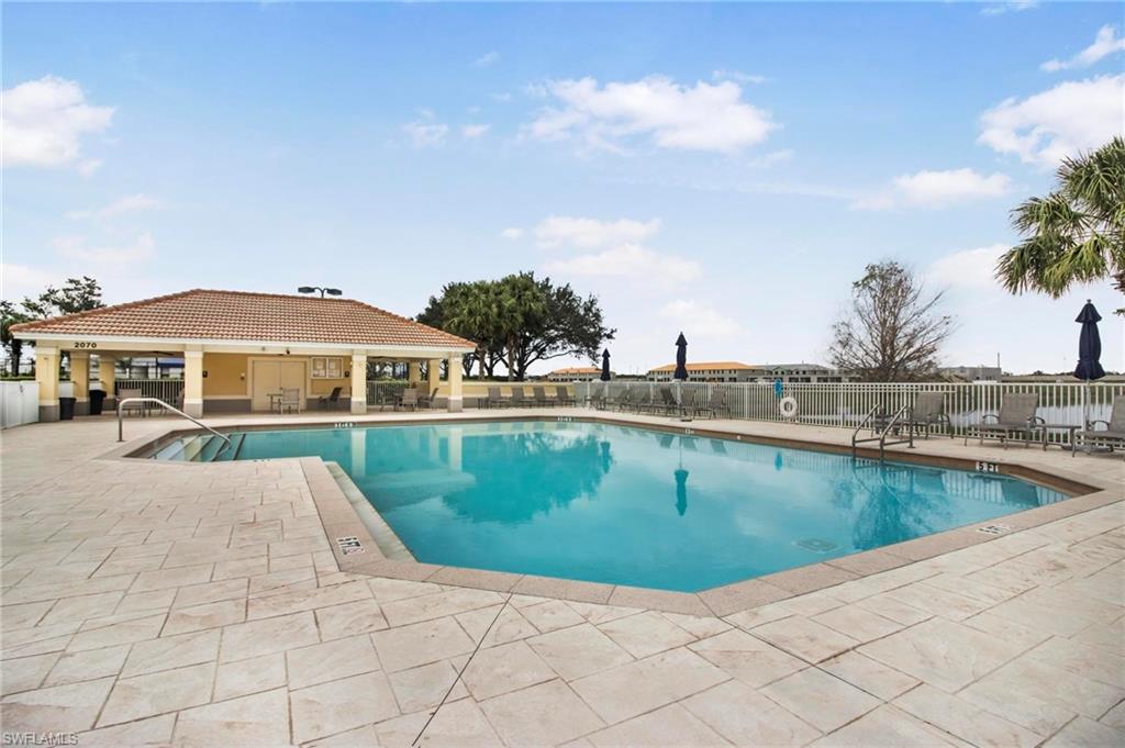 2265 Avocado Lane Naples, FL 34102 - Photo 27 of 32 a view of swimming pool with outdoor seating and plants