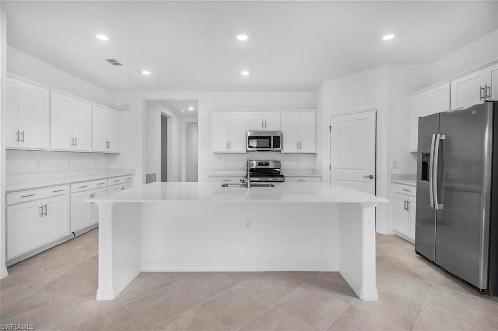 2265 Avocado Lane Naples, FL 34102 - Photo 6 of 32 a large kitchen with cabinets