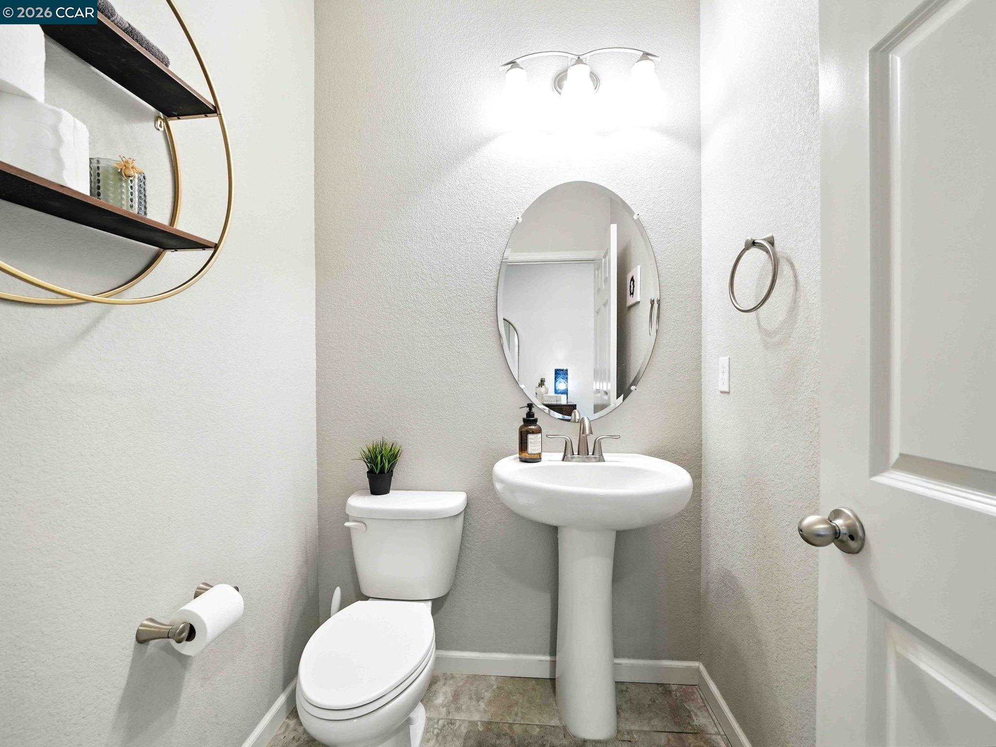 2433 Sanders Lane Fairfield, CA 94533 - Photo 16 of 51 a bathroom with a toilet a sink and mirror