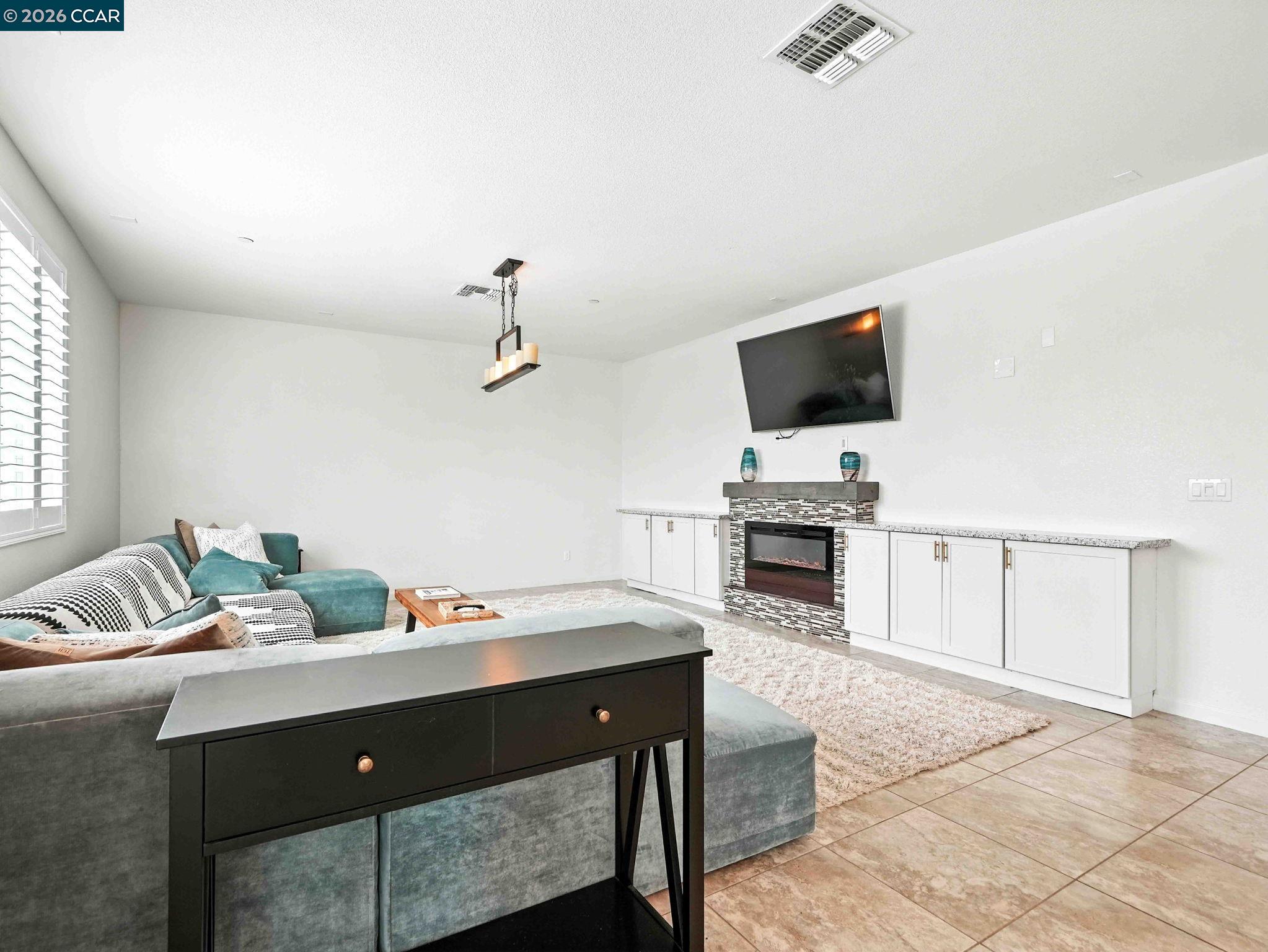 2433 Sanders Lane Fairfield, CA 94533 - Photo 22 of 51 a living room with fireplace furniture and a flat screen tv
