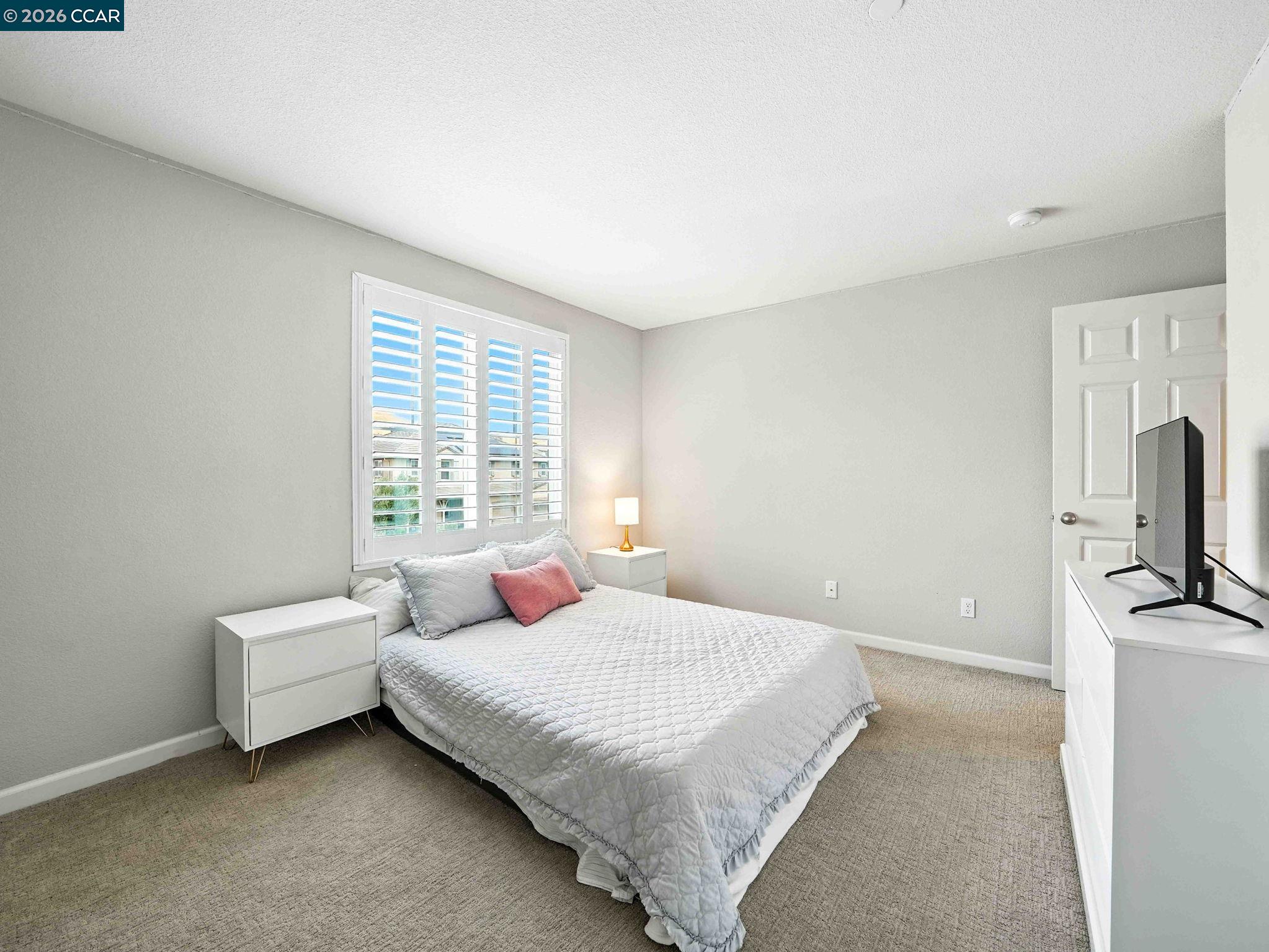 2433 Sanders Lane Fairfield, CA 94533 - Photo 25 of 51 a bedroom with a bed a flat screen tv and window