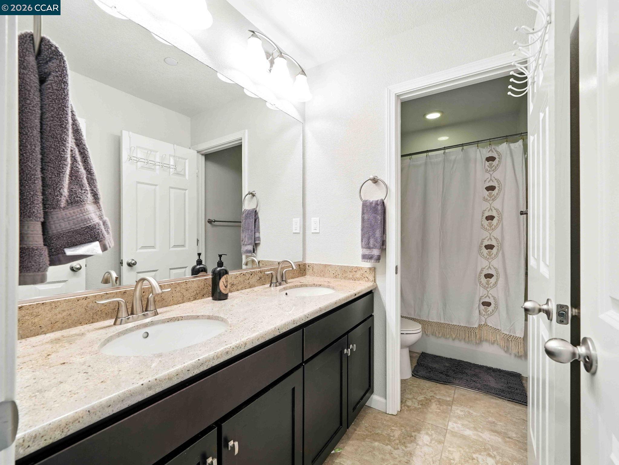 2433 Sanders Lane Fairfield, CA 94533 - Photo 27 of 51 a bathroom with a granite countertop sink mirror and double