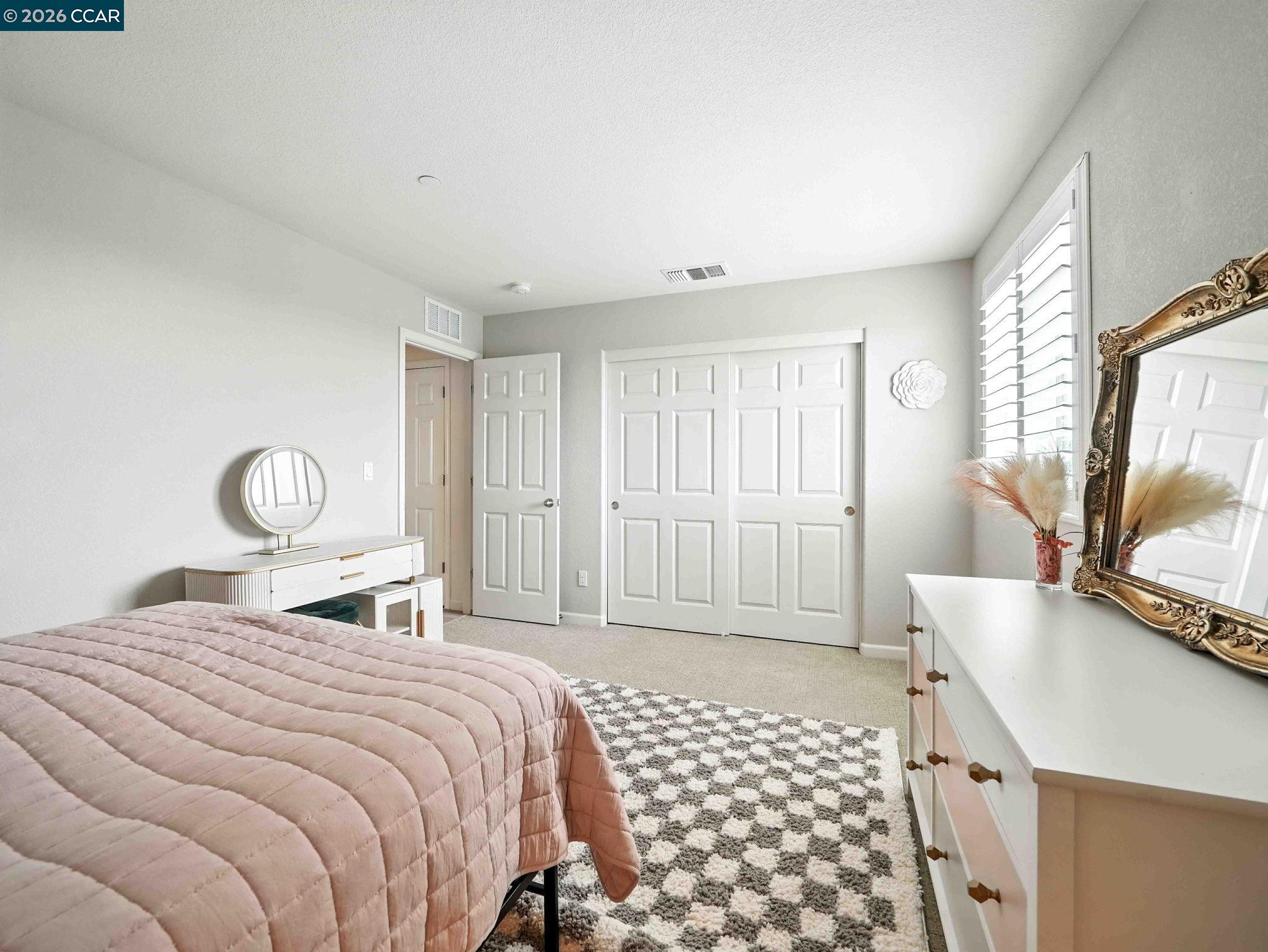 2433 Sanders Lane Fairfield, CA 94533 - Photo 29 of 51 a bedroom with a bed a mirror and a window