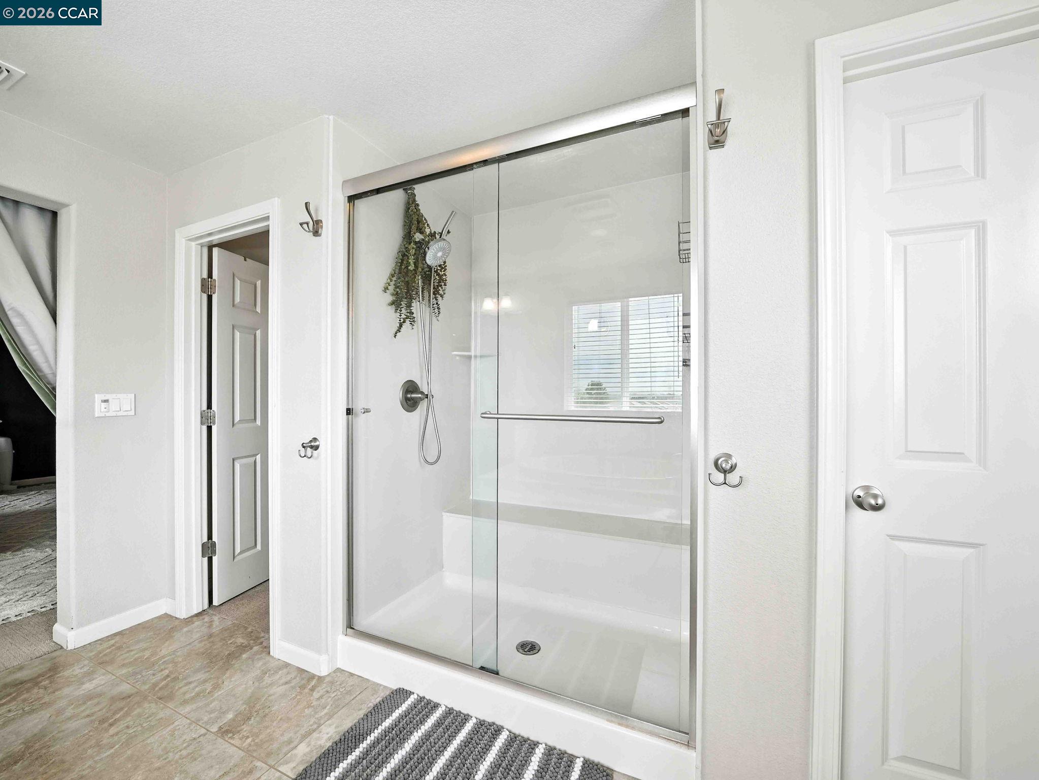 2433 Sanders Lane Fairfield, CA 94533 - Photo 34 of 51 a bathroom with a glass shower door and a glass door