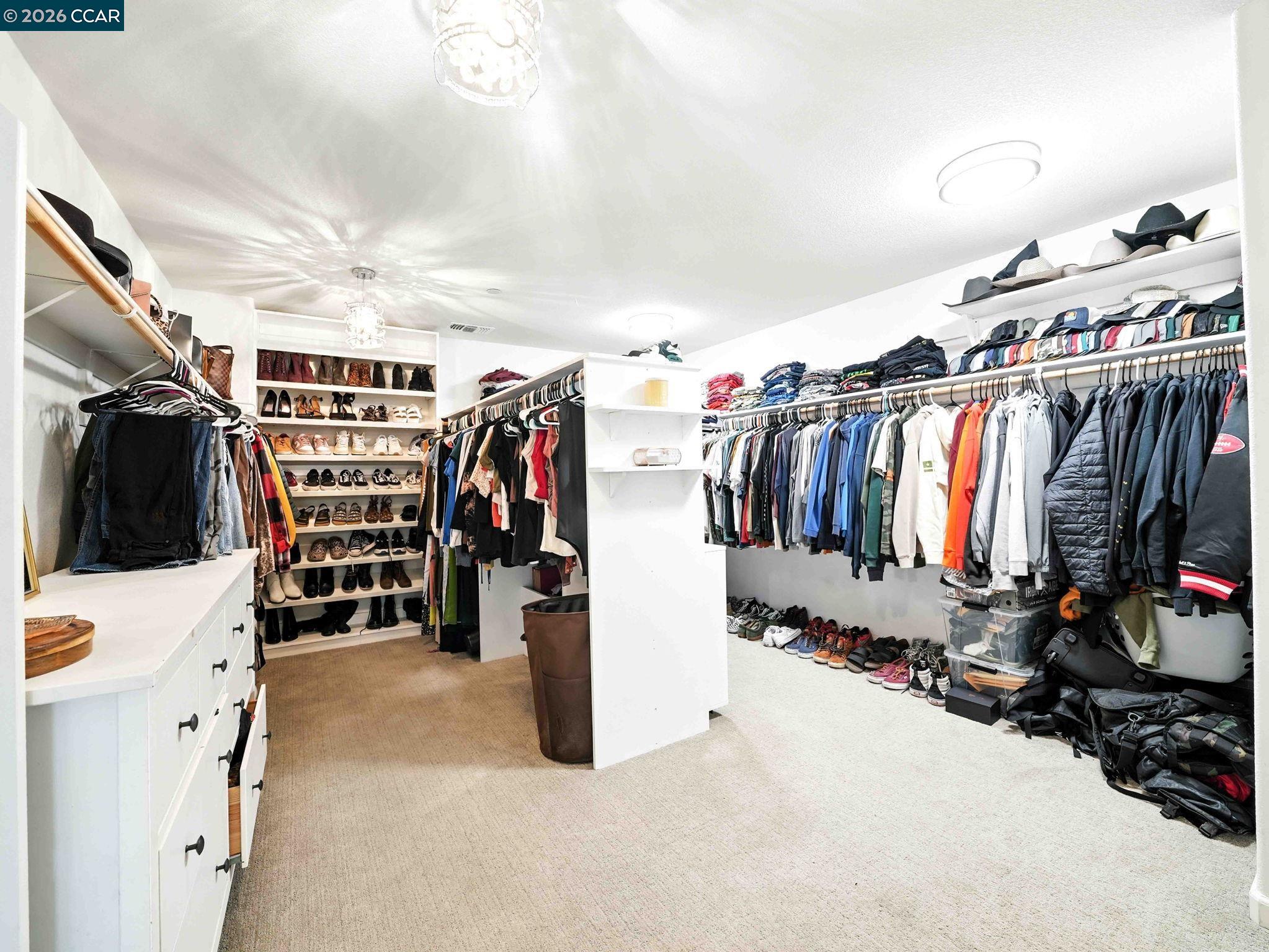2433 Sanders Lane Fairfield, CA 94533 - Photo 36 of 51 a view of walk in closet with clothes and shoes