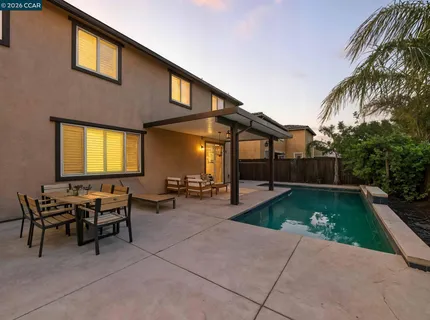 a view of a backyard with swimming pool