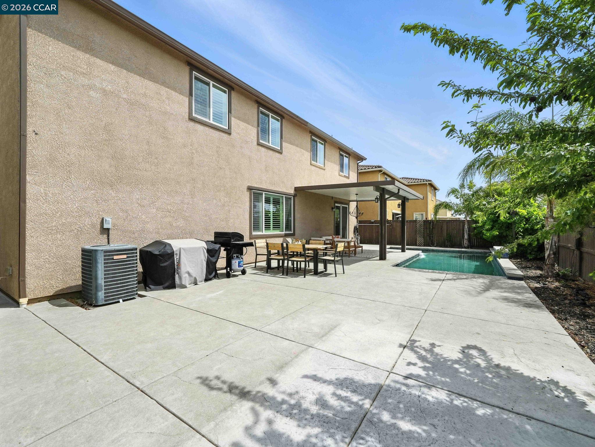 2433 Sanders Lane Fairfield, CA 94533 - Photo 41 of 51 a view of a patio with table and chairs potted plants and a palm tree