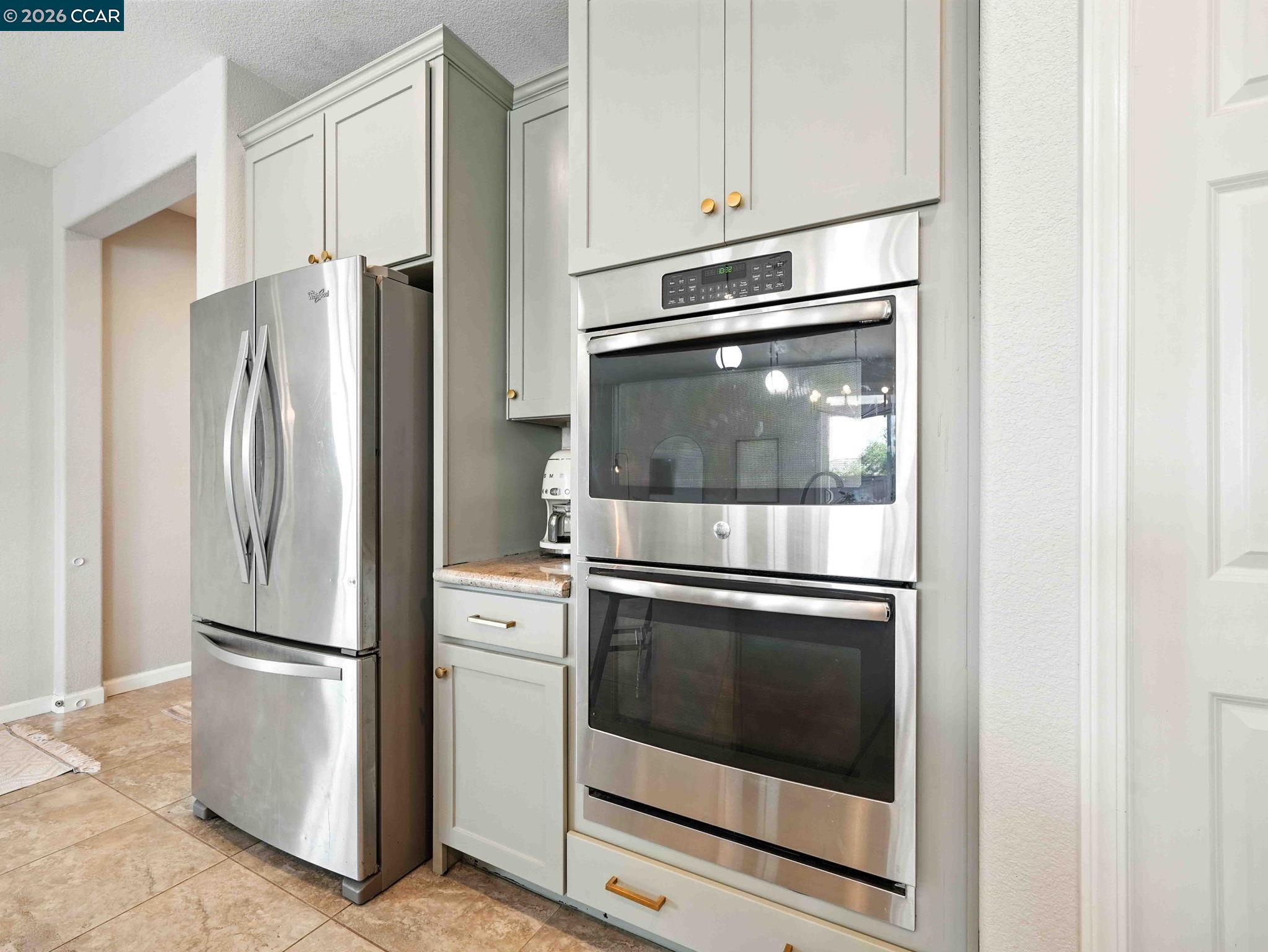 2433 Sanders Lane Fairfield, CA 94533 - Photo 8 of 51 a kitchen with cabinets and stainless steel appliances