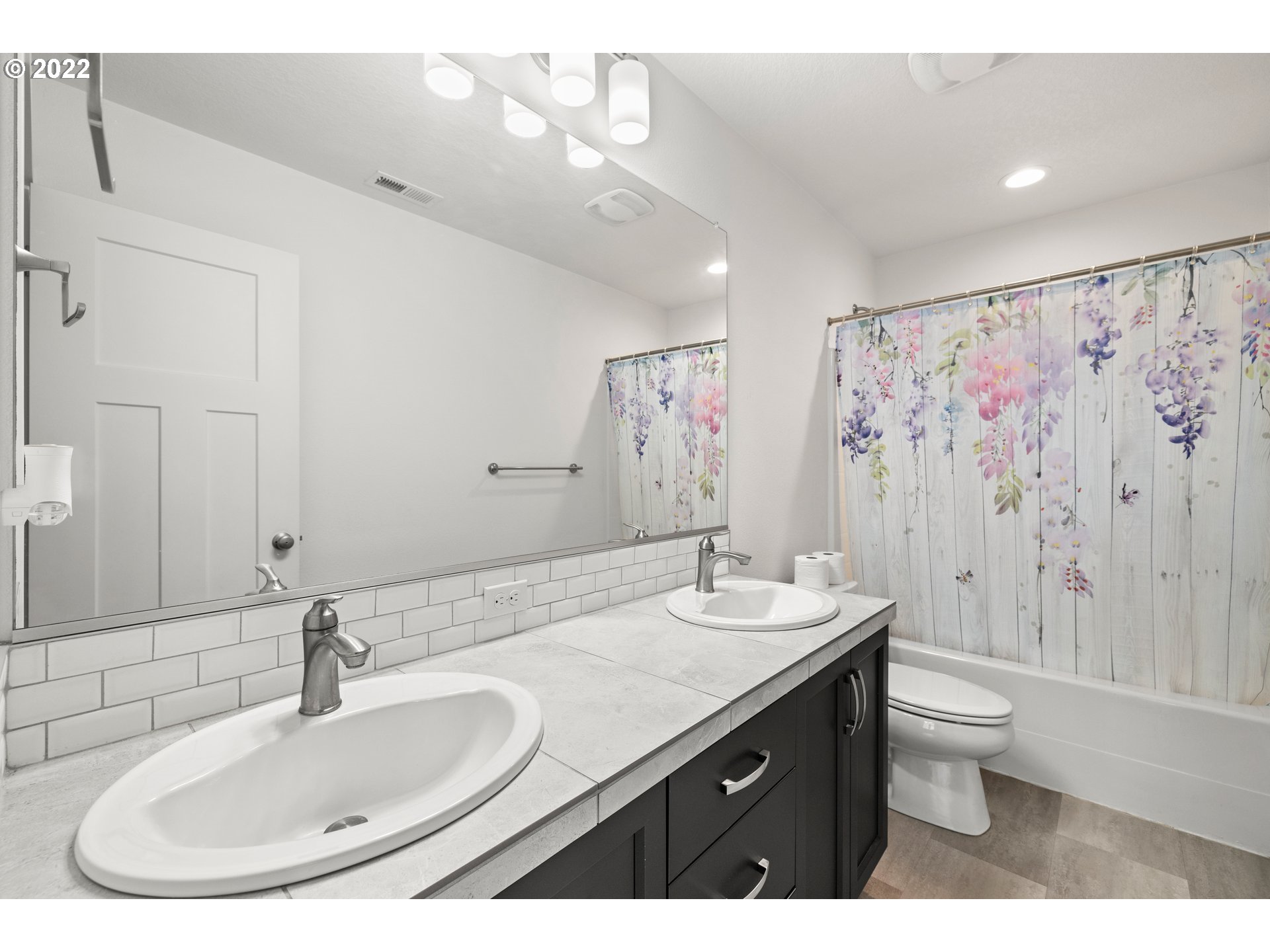 951 Southwest Draper Terrace Beaverton, OR 97003 - Photo 20 of 32 a bathroom with a double vanity sink toilet and a mirror