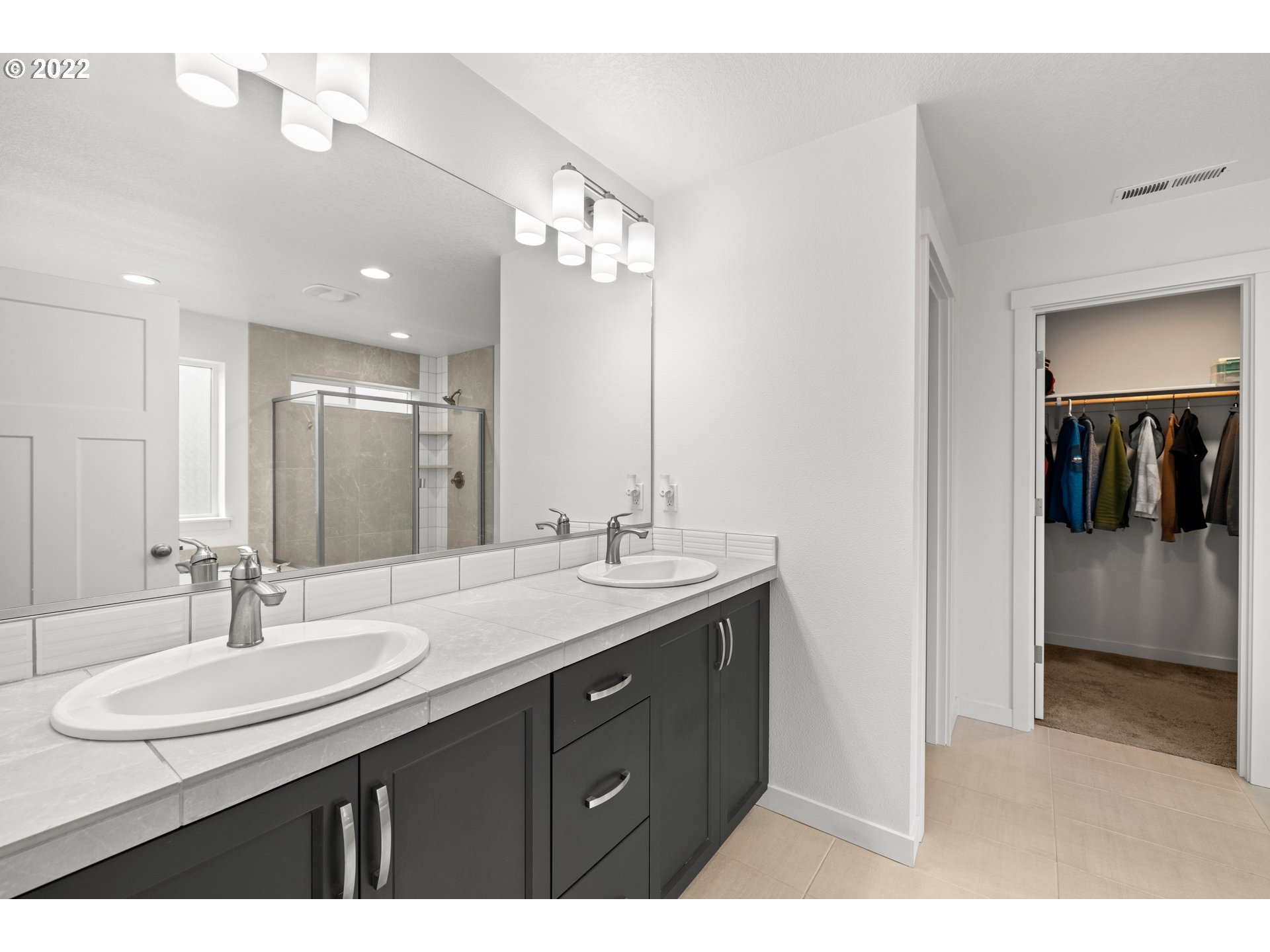 951 Southwest Draper Terrace Beaverton, OR 97003 - Photo 23 of 32 a bathroom with a sink double vanity and a mirror