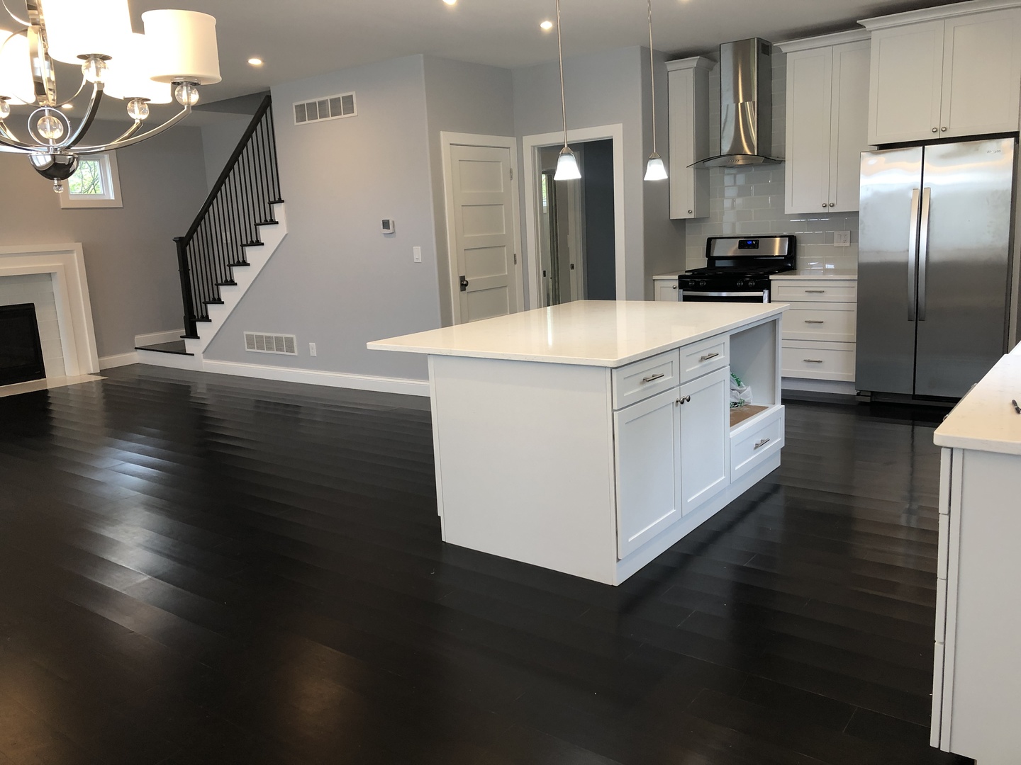 2517 East 275th Road Peru, IL 61354 - Photo 4 of 15 a kitchen with stainless steel appliances a kitchen island wooden floors and a view of living room