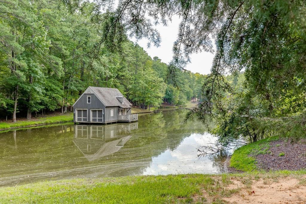 5775 Kennedy Road Suwanee, GA 30024 - Photo 13 of 23 a view of a lake with a yard and large trees