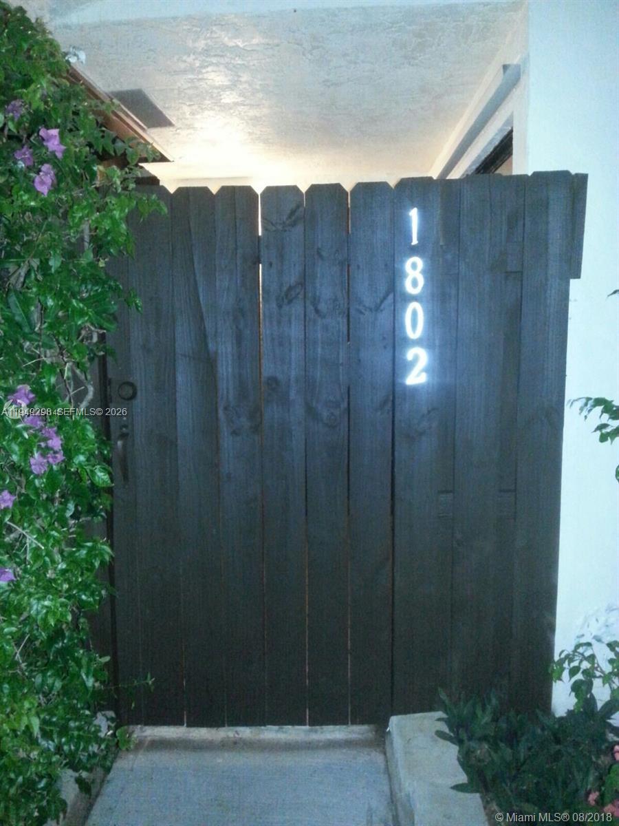 1802 Waterview Circle, Unit 1802 Palm Springs, FL 33461 - Photo 1 of 20 a view of a wooden fence